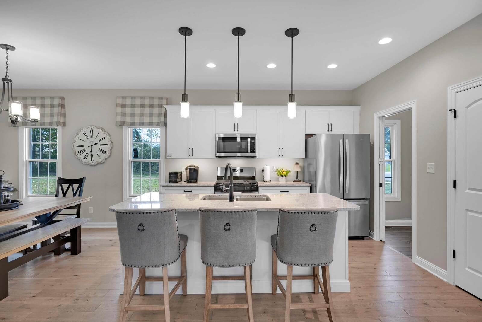 Modern kitchen with island and pendant lights.