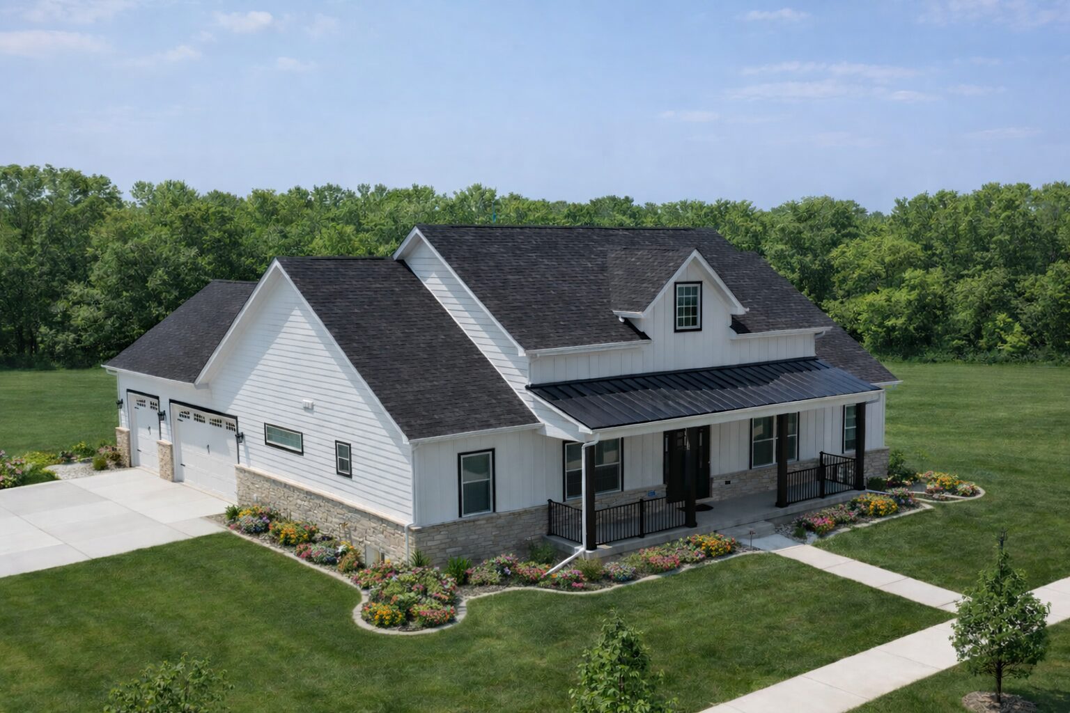 White farmhouse with stone base and covered porch