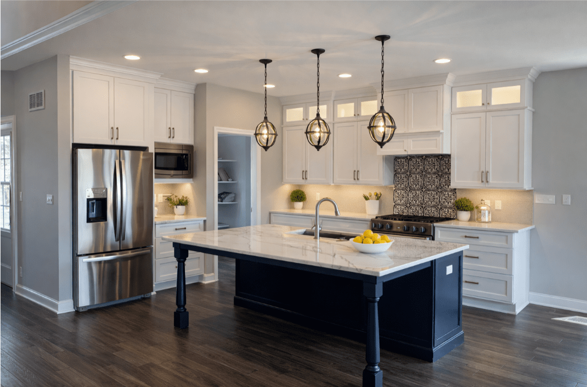 Modern kitchen with island and pendant lights.
